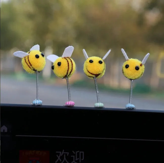 Swing spring bee car decoration made from soft fur ball, showing cartoon bee shape.