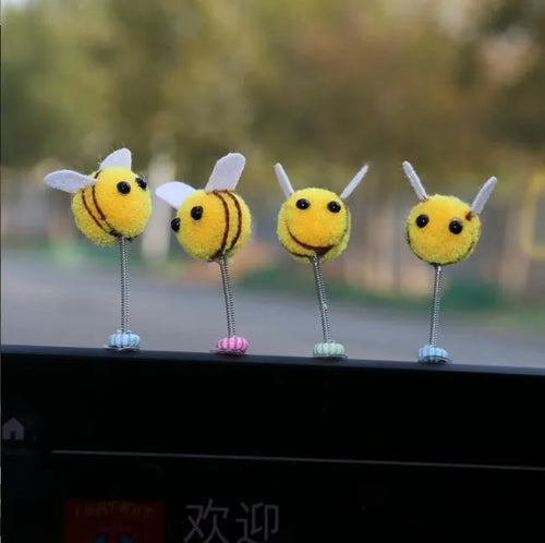 Swing spring bee car decoration made from soft fur ball, showing cartoon bee shape.