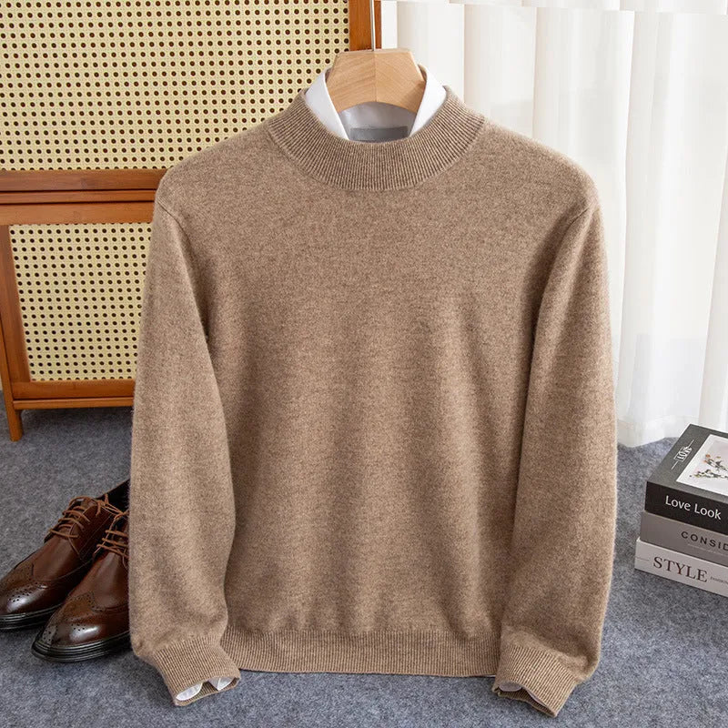 Man wearing a half-collar loose wool sweater in a textured rough yarn knit.