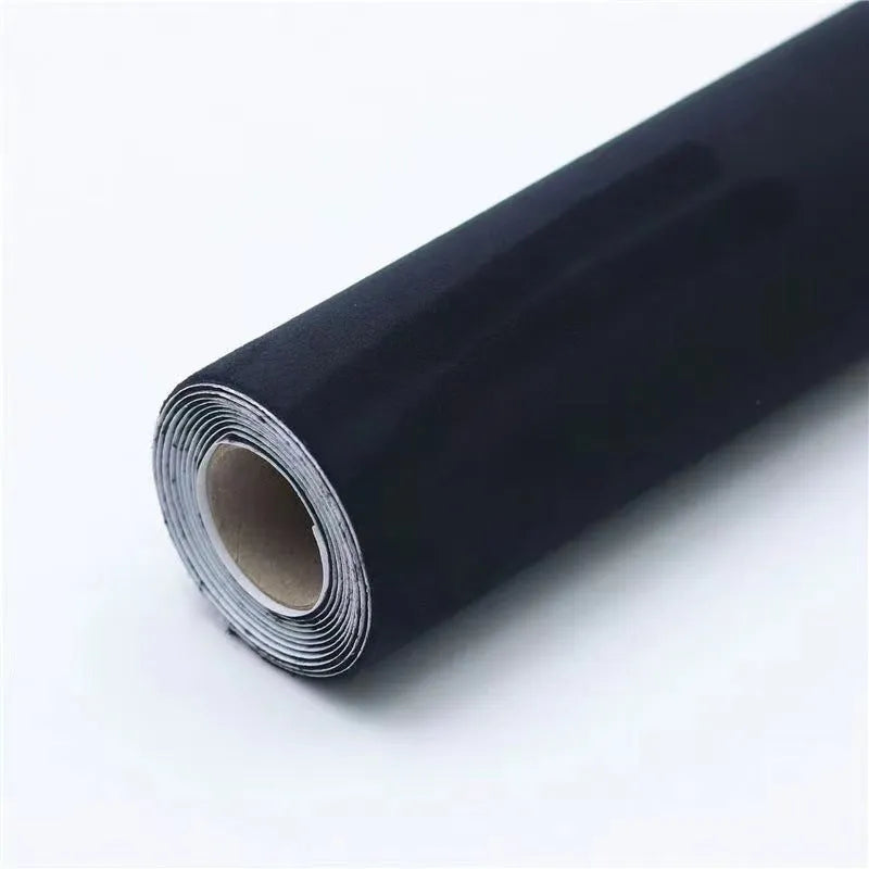 A sheet of self-adhesive black leather suede material with a ruler showing its 0.5mm thickness.