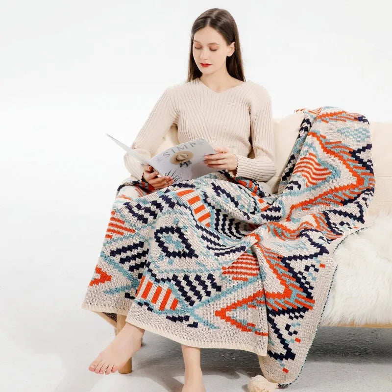 Acrylic sofa blanket with tassels in geometric pattern colour option on a sofa