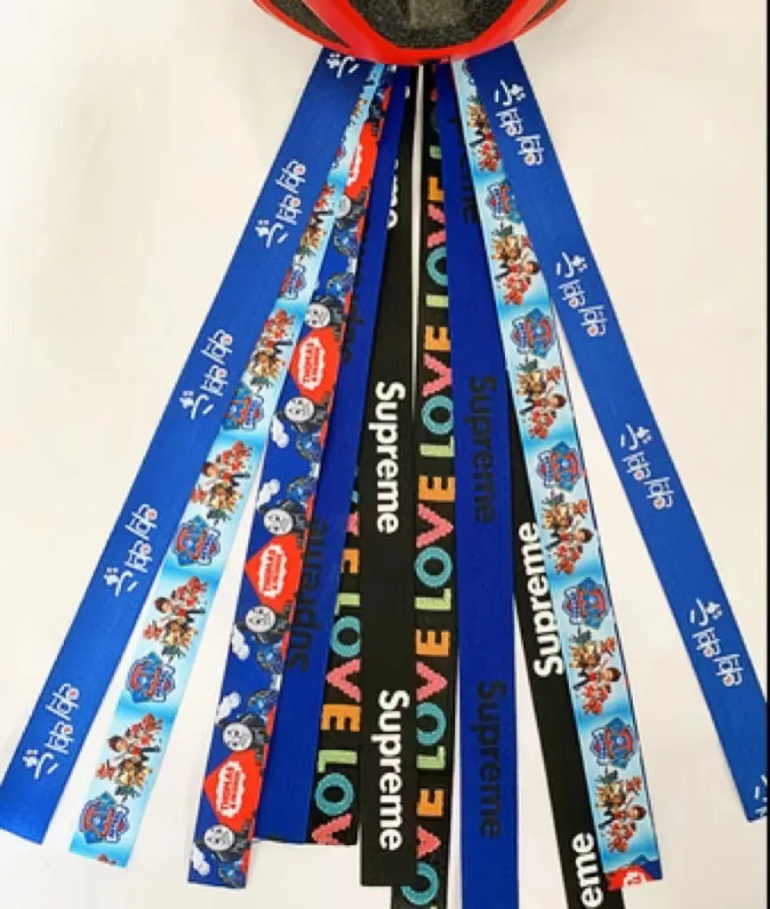 A colourful helmet streamer accessory for children's sports helmets and doll decoration.