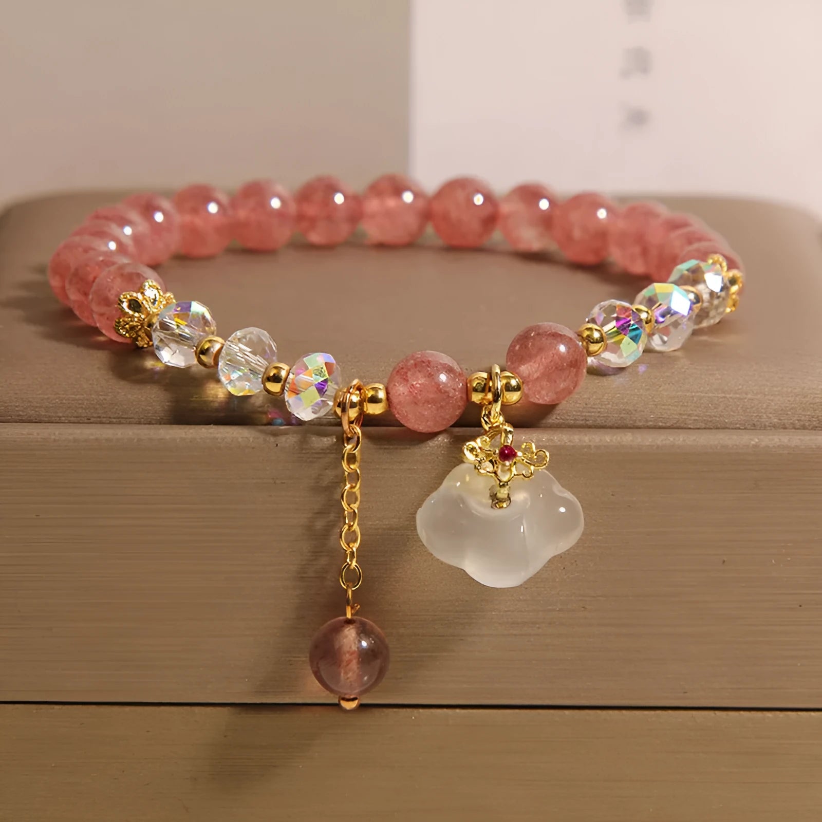 Women's adjustable crystal bracelet with strawberry quartz and white agate beads showing adjustable chain detail