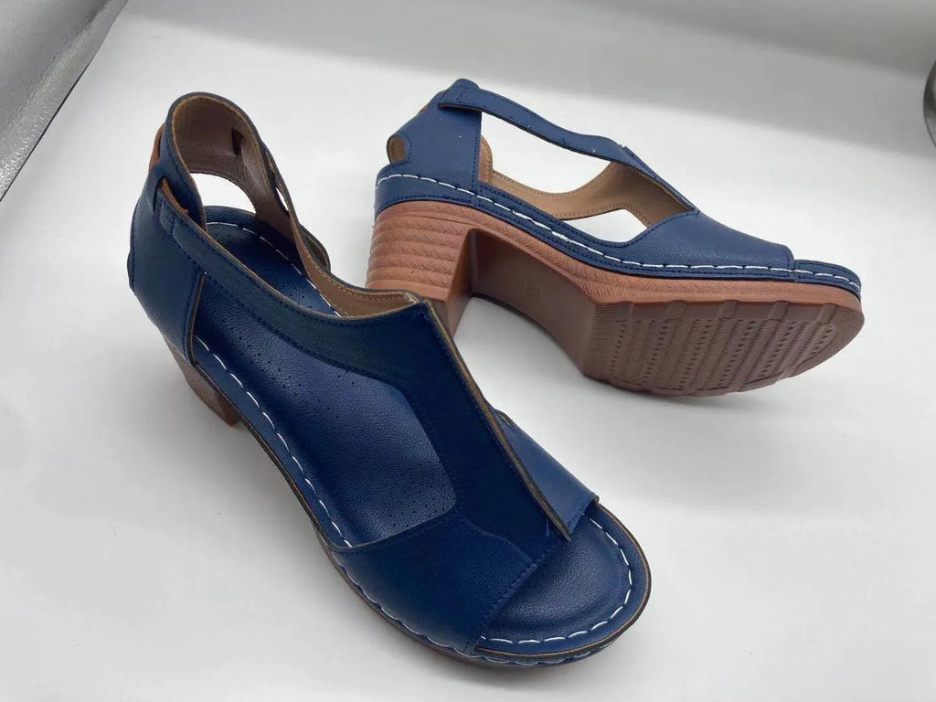 Women's beige peep toe wedge sandals with a buckle strap and low Roman-style heel.