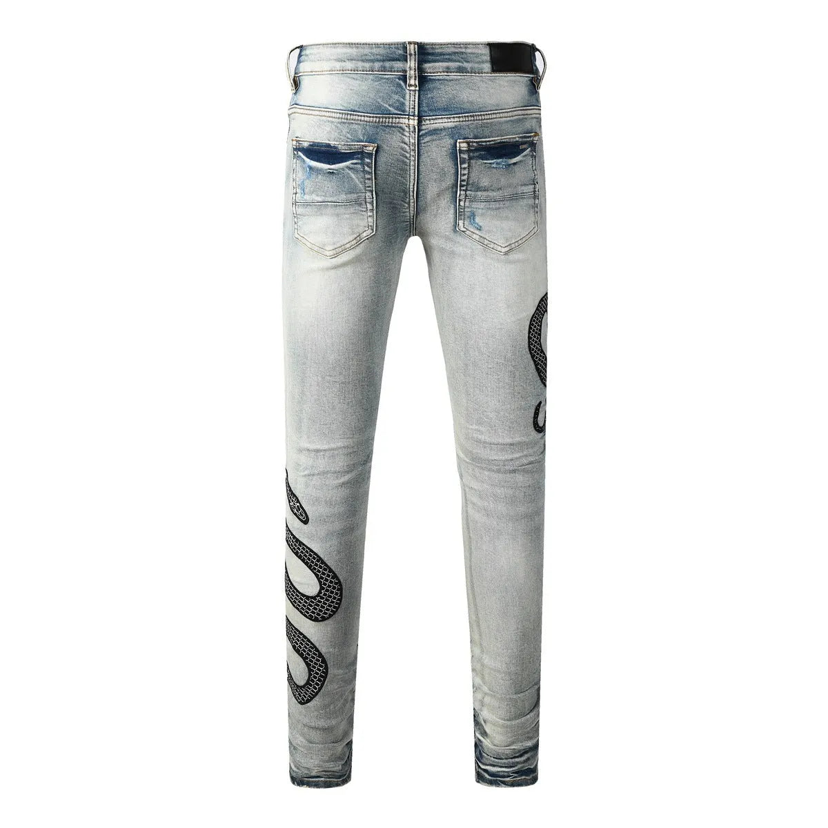 Blue distressed skinny jeans with button fly and tapered leg in street fashion style