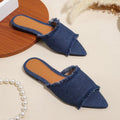 Women's denim flat slippers with a tassel, leather lining, and a PVC sole in various colours.