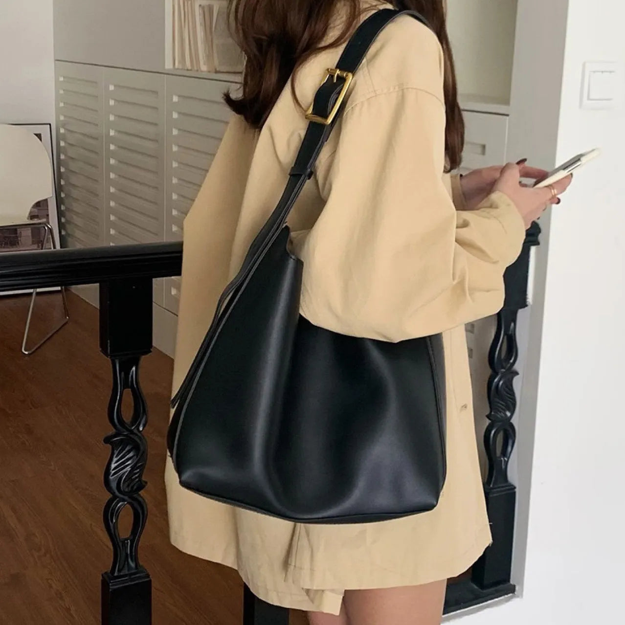 Women's soft PU leather shoulder bag with swing threads in black and brown colours showing ribbon and pocket detailing