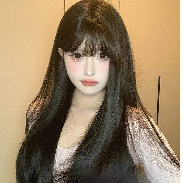 Dark brown long straight synthetic wig with a full fringe on a wig head.