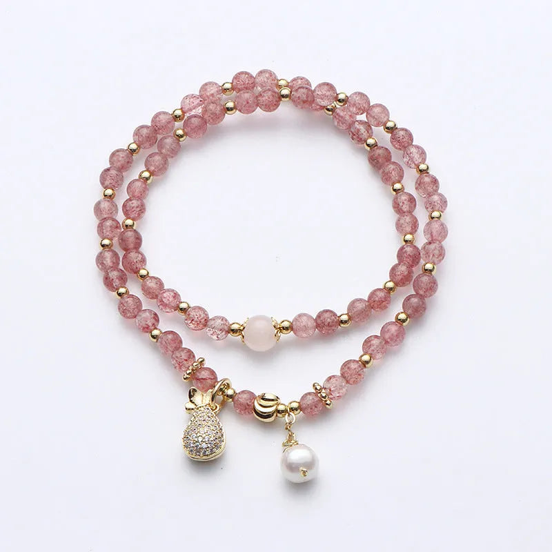 Women's strawberry quartz bracelet with geometric wallet-style design and adjustable beaded construction