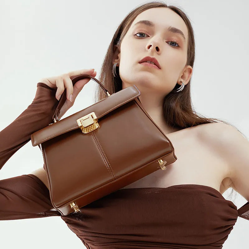 Women's genuine leather shoulder bag with vachette clasp in horizontal square design showing internal compartments
