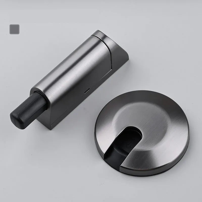 Zinc alloy invisible door stopper in brushed nickel finish on a wooden floor