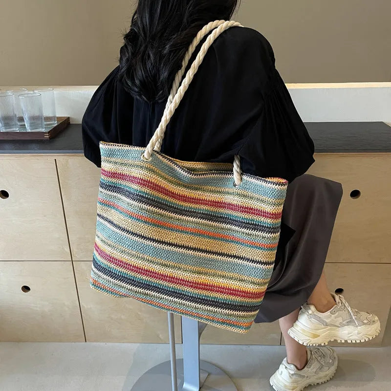 Blue woven nylon shoulder bag with straw-inspired basket construction and polyester lining