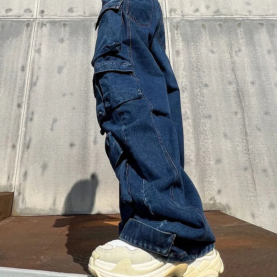 Dark blue wide-leg jeans with distressed detailing, high waist, and multiple pockets on mannequin