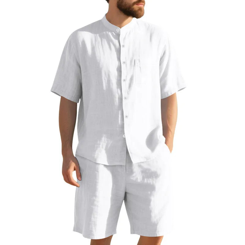 Man wearing a light blue short-sleeve linen blend suit jacket and matching shorts with a Henry collar.