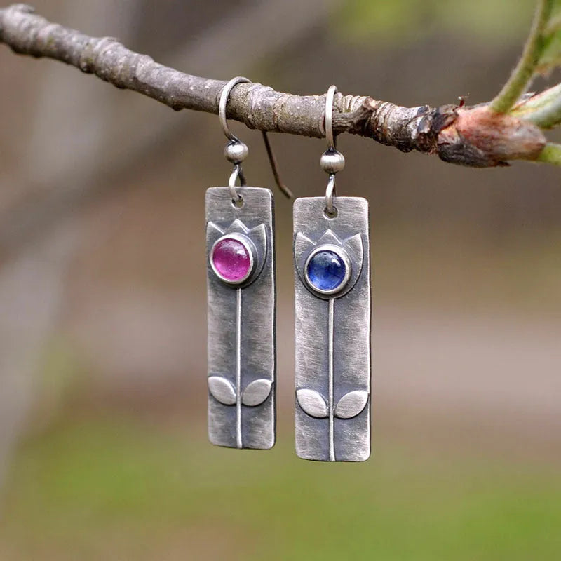 Geometric red sapphire earrings for women with an antique finish and ellipse details.