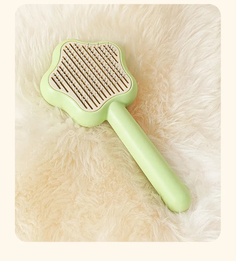 Self-cleaning stainless steel cat comb magic wand measuring 20cm with green or yellow colour options