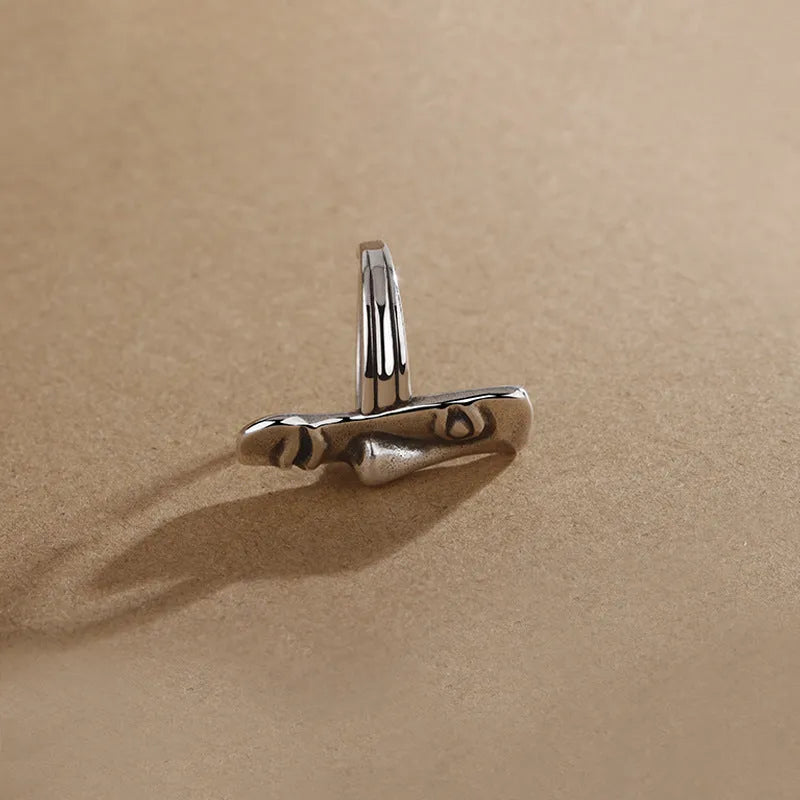 Copper retro half face mask ring with electroplated finish and adjustable opening on a neutral background.