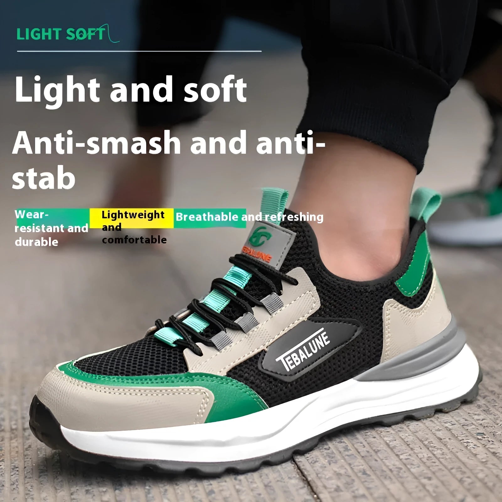 Black and green low-top safety shoe with mesh upper and plastic steel toe cap on a white background.
