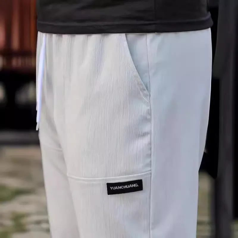 Men's casual polyester trousers for spring and autumn in light grey colour.