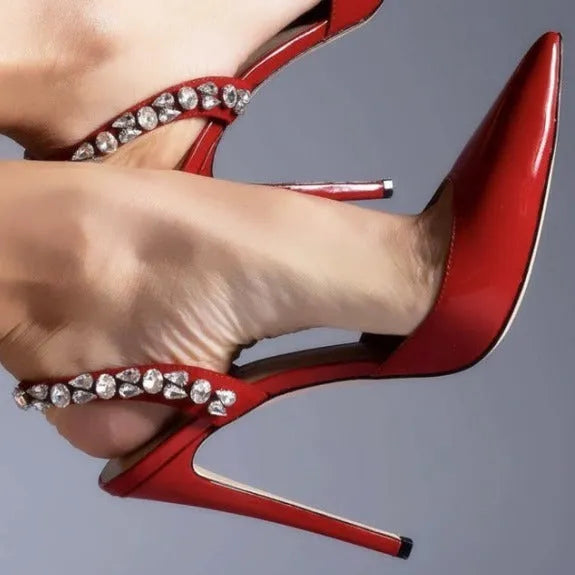 Pointed toe high heel sandals with rhinestone detail on the side, shown in patent leather.
