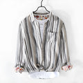 A man's casual red and grey striped linen shirt with long sleeves, laid flat to show its loose fit.