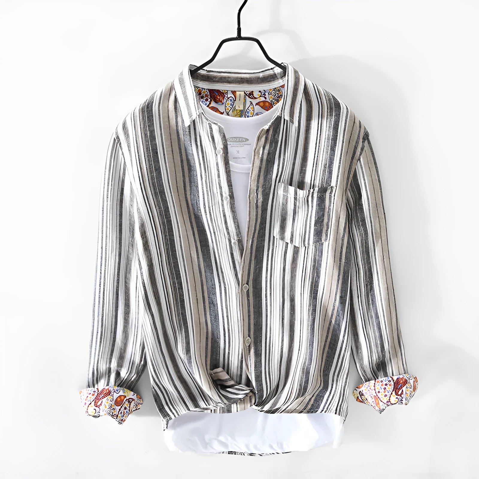 A man's casual red and grey striped linen shirt with long sleeves, laid flat to show its loose fit.