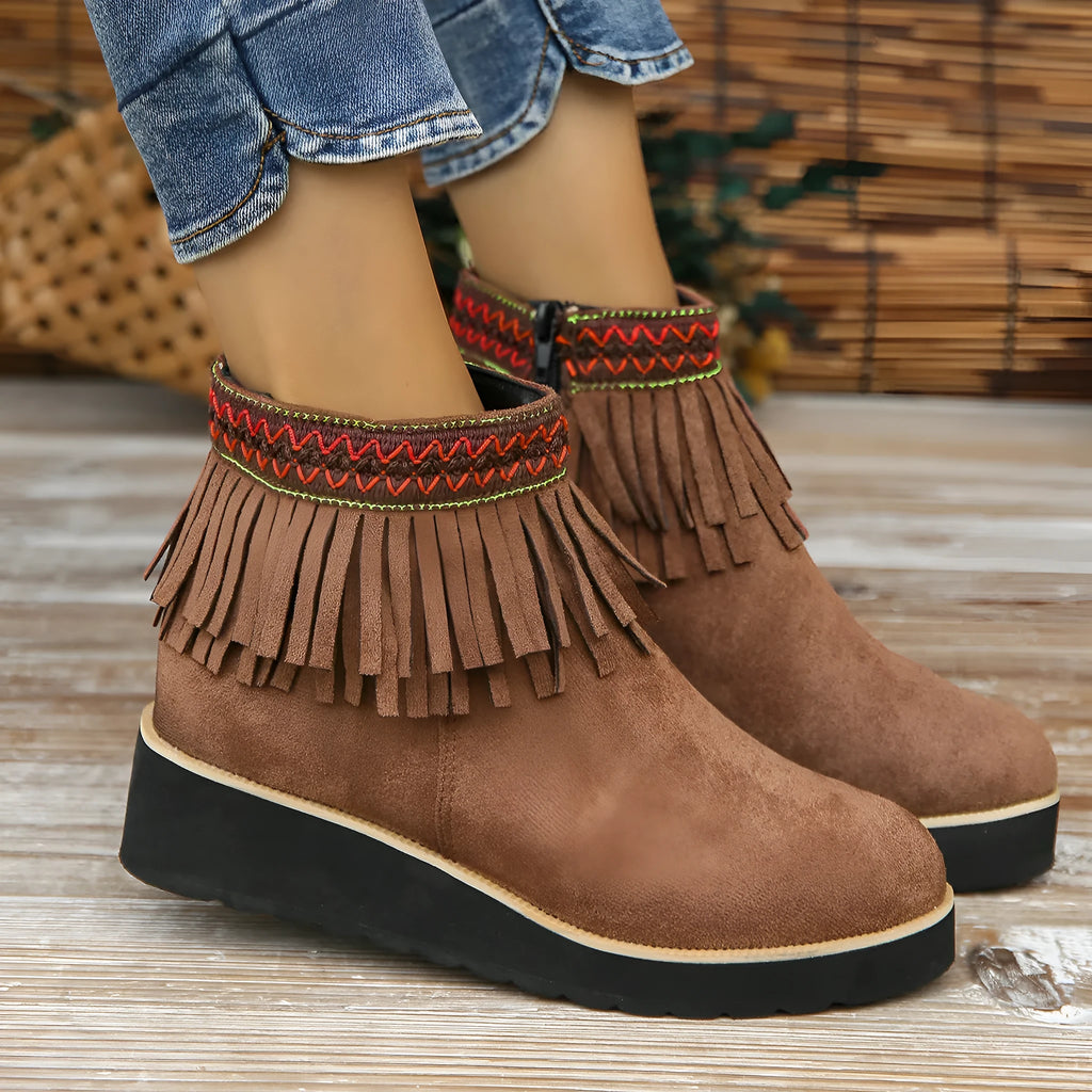 Women's dark brown suede ankle boot with wedge heel, side zipper, and decorative tassel.