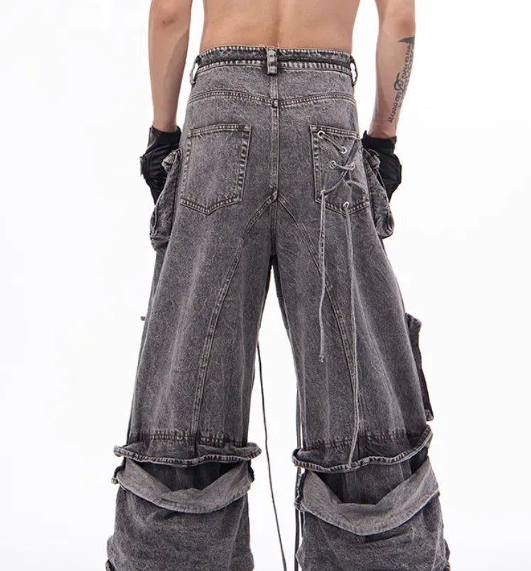 Grey distressed denim overalls for men with rope stitching on the legs and a mop pant cut.