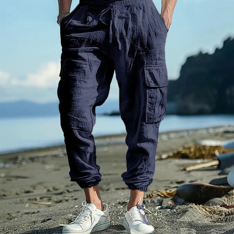 Men's linen casual trousers with ankle-tied design and multiple pockets in army green colour.