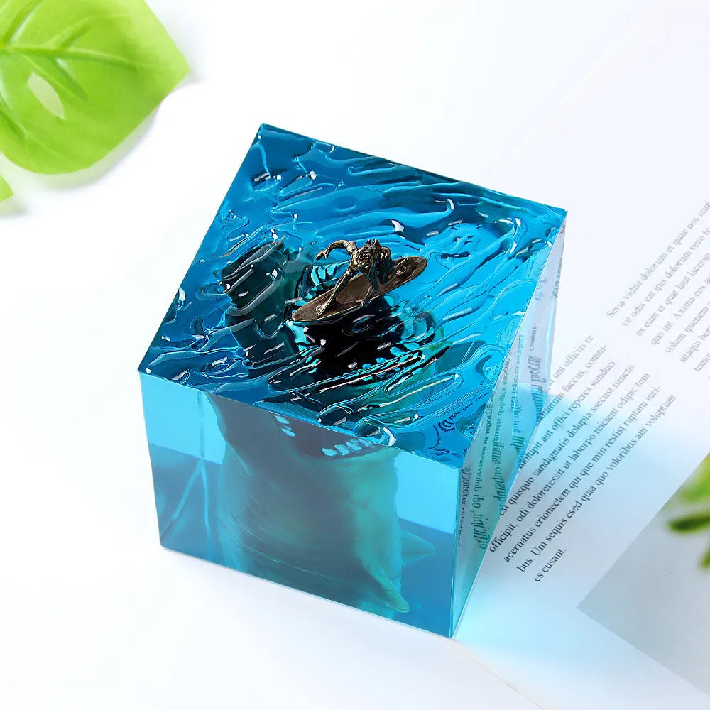 Epoxy resin shark surfer night light ornament with crystal glue details on blue background