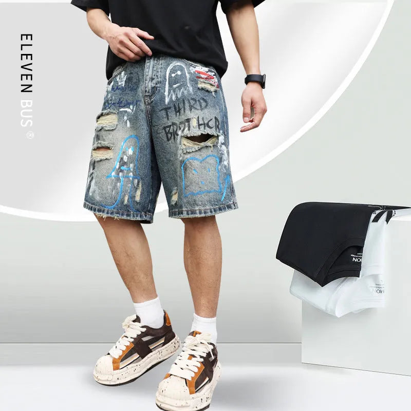Blue men's ripped denim shorts with graffiti details and straight-leg cut