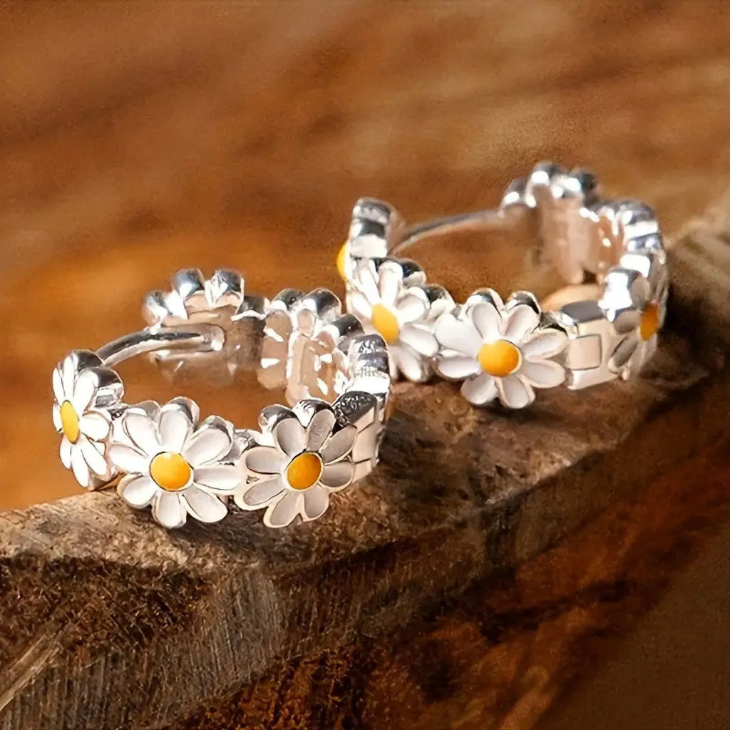 White platinum electroplated daisy flower ring earrings with K-platinum gem accents on a copper base.