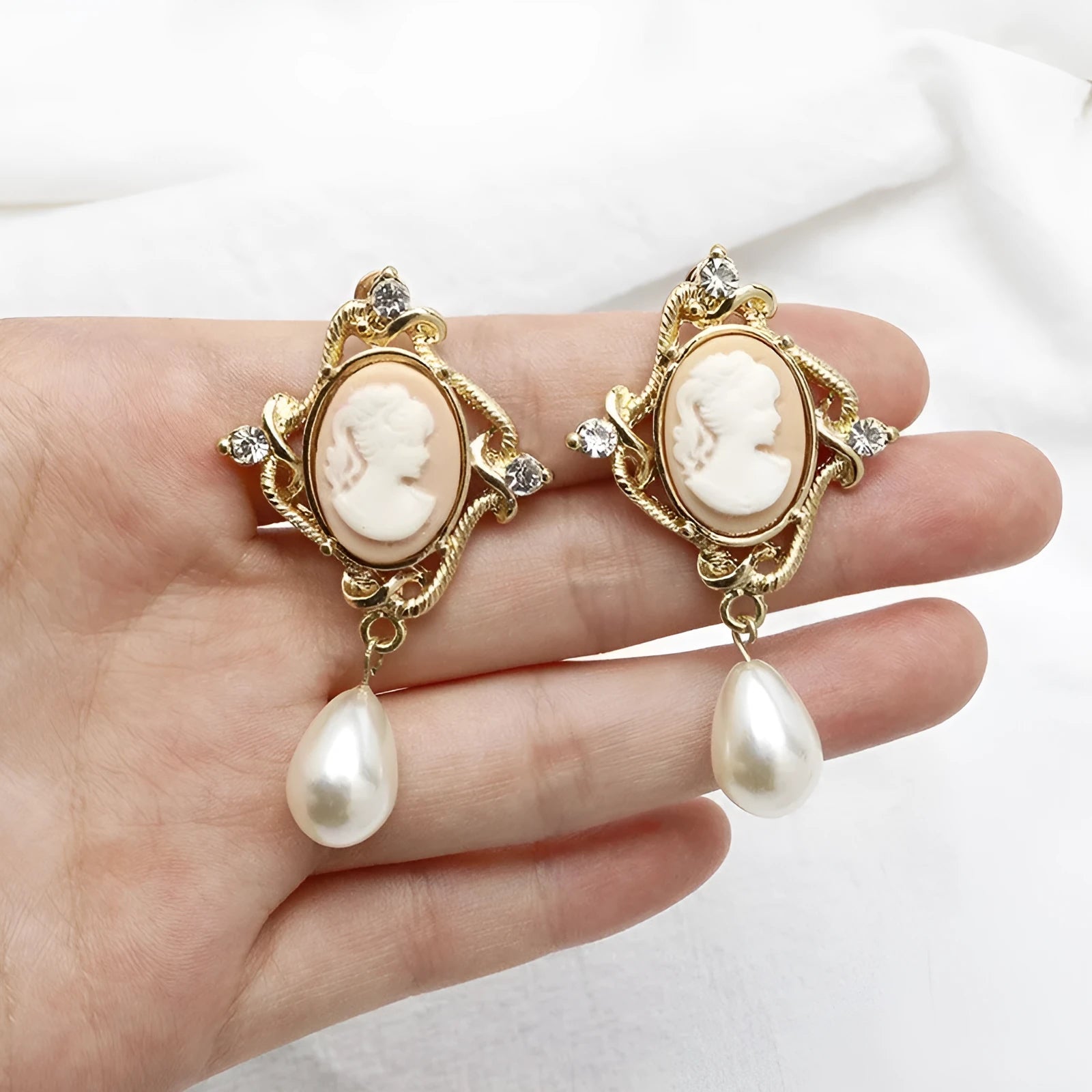 Gold alloy retro embossed geometric earrings on a surface