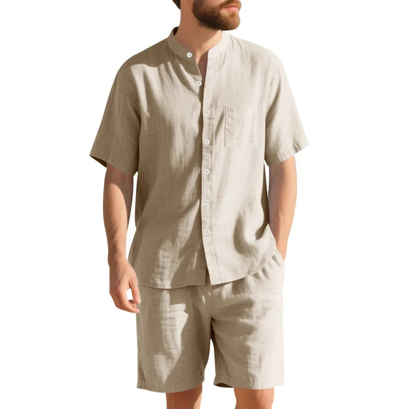 Man wearing a light blue short-sleeve linen blend suit jacket and matching shorts with a Henry collar.