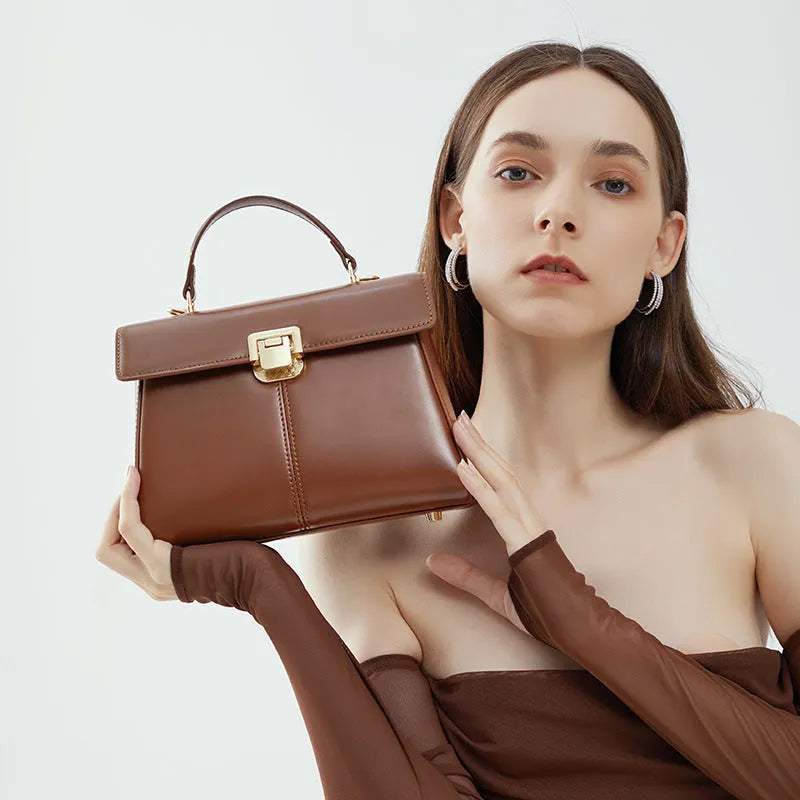 Women's genuine leather shoulder bag with vachette clasp in horizontal square design showing internal compartments