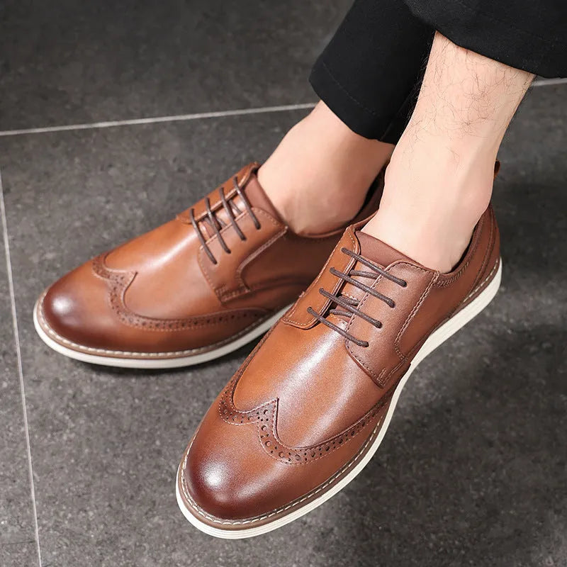 Men's black slip-on casual shoe with round toe and carved detail on the PU upper.
