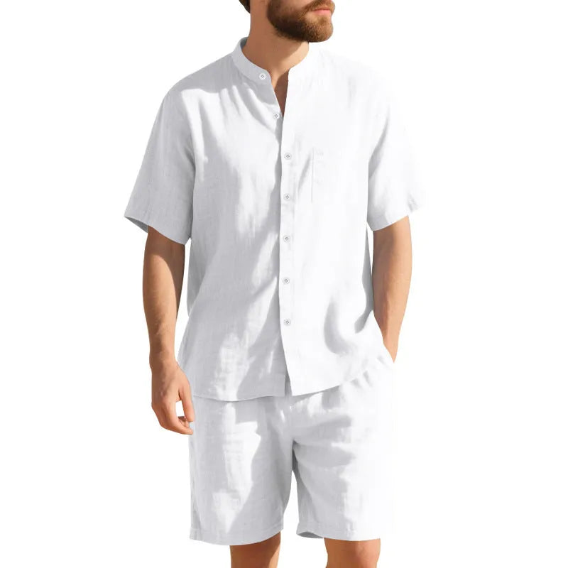 Man wearing a light blue short-sleeve linen blend suit jacket and matching shorts with a Henry collar.