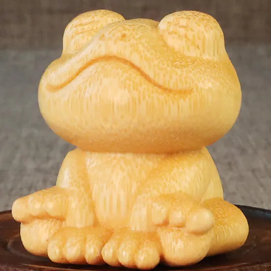 Solid bamboo carving ornament of smiling frog design measuring 5cm height and 4.5cm diameter