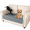 Reversible dark grey and light grey waterproof dog sofa cushion on a leather sofa