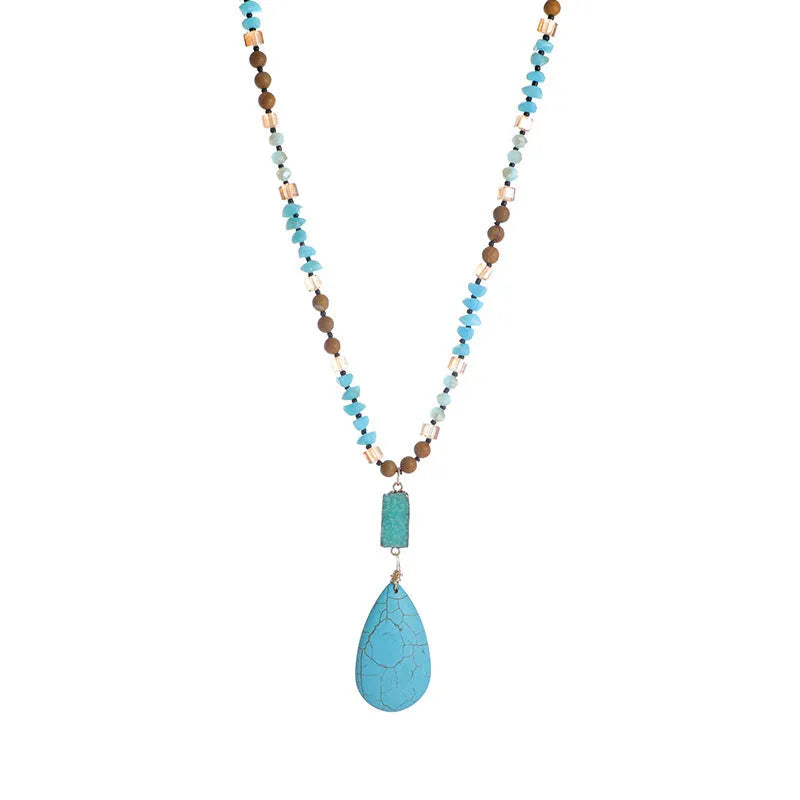 Turquoise blue water drop pendant necklace with geometric shapes on a long ball bead chain.
