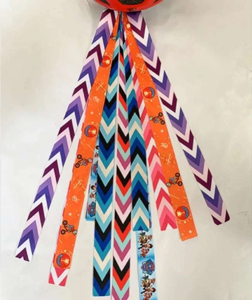 A colourful helmet streamer accessory for children's sports helmets and doll decoration.