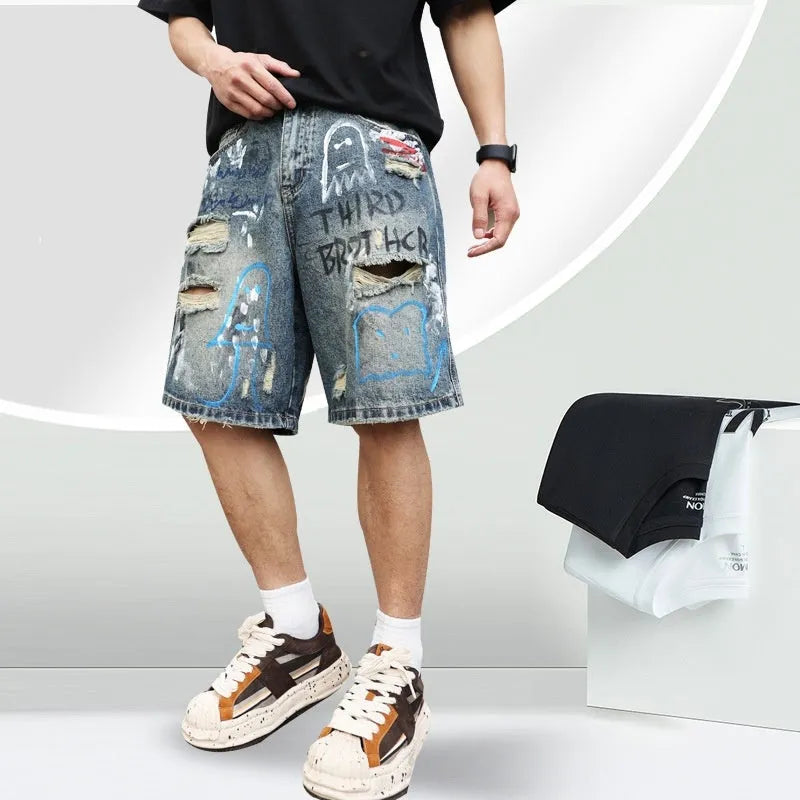 Blue men's ripped denim shorts with graffiti details and straight-leg cut