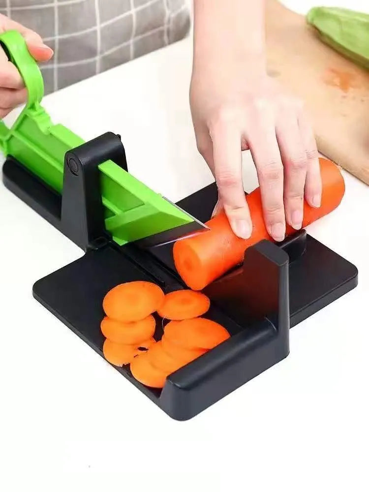 Green and red modern vegetable cutter with stainless steel blades for slicing carrots and potatoes.