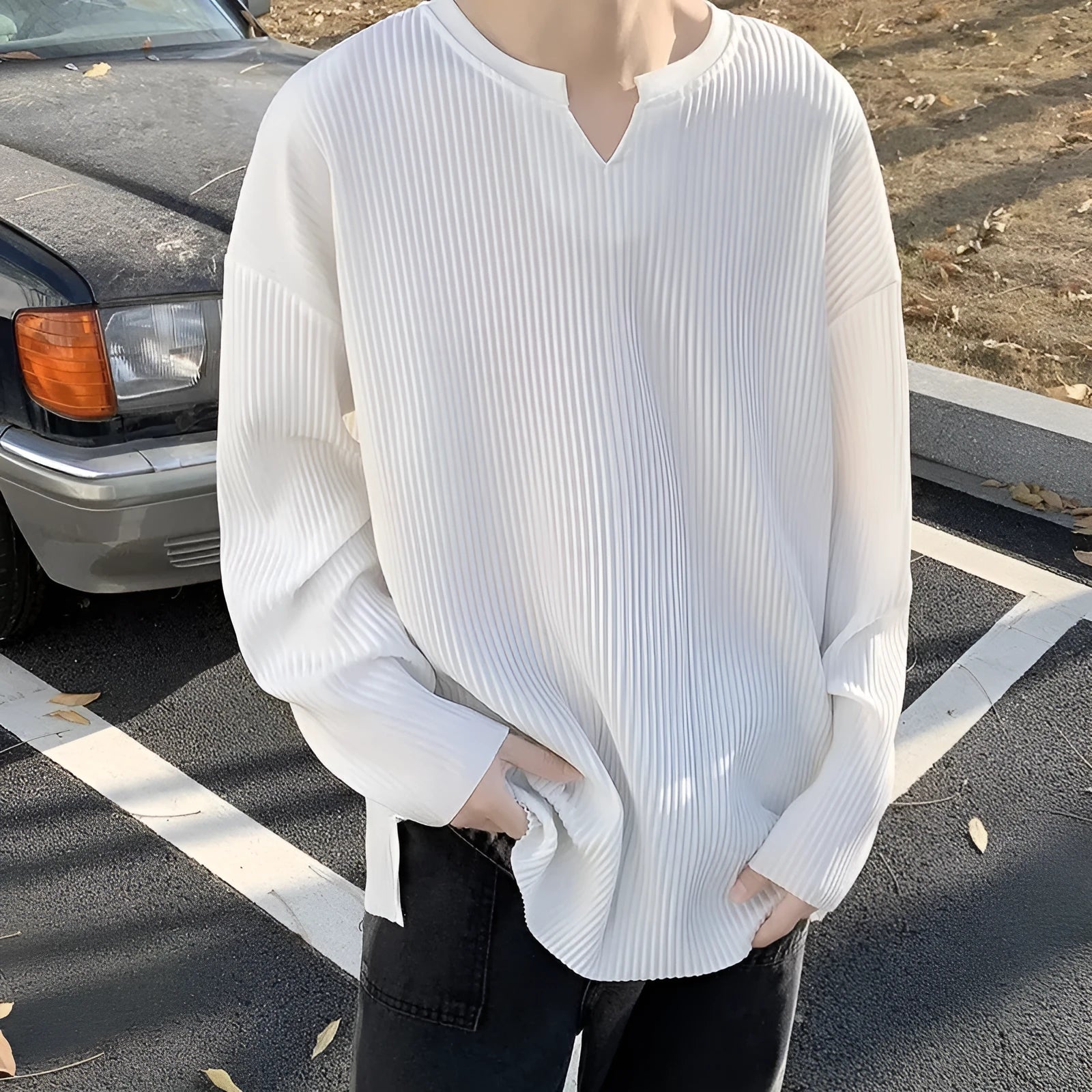 Women's plus size striped texture pullover top in grey, showing loose fit and long sleeves.