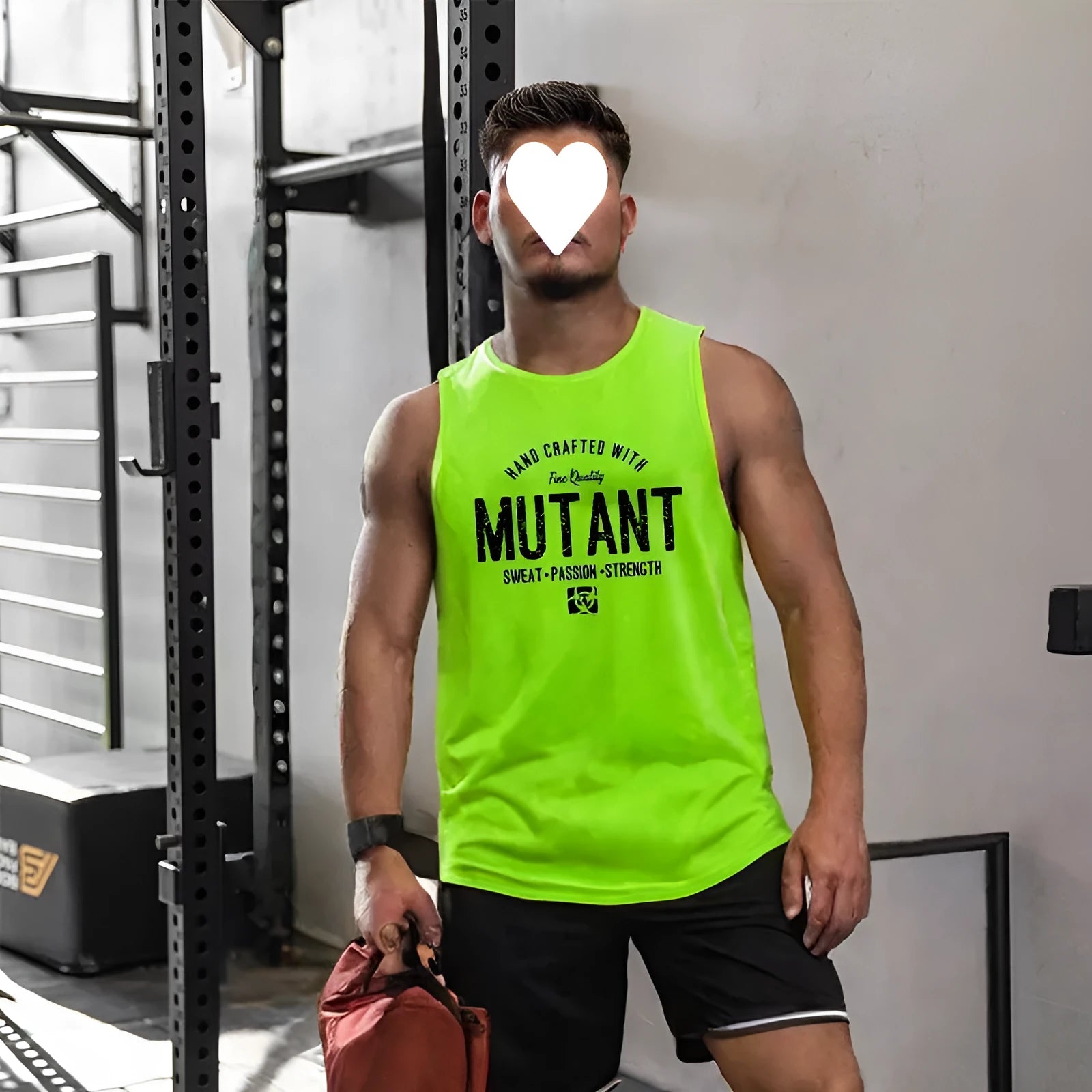 Man wearing a loose grey sleeveless polyester fitness vest for gym workouts.
