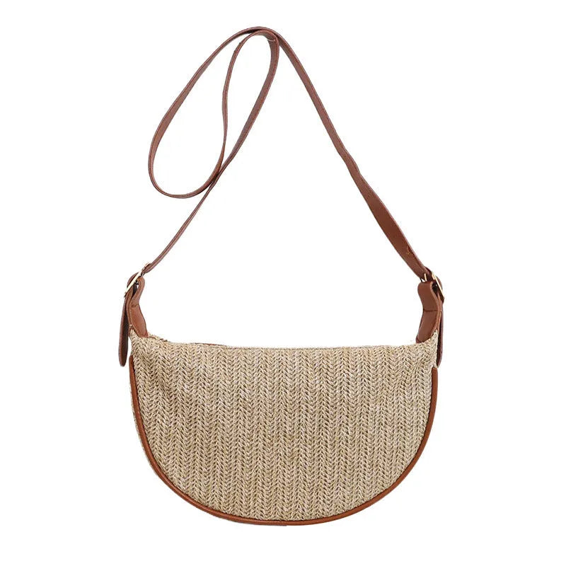 Women's straw woven crossbody bag showing woven texture and internal phone and document compartments