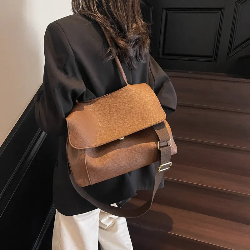 PU leather tote bag in beige with double shoulder strap and visible stitching detail.