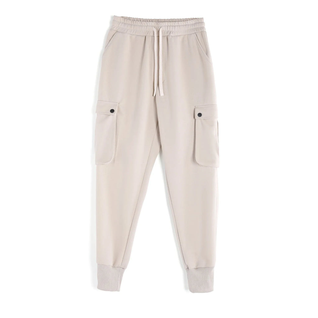 Men's loose fit cotton trousers with ankle-tied cuffs and multiple pockets in a light grey colour.