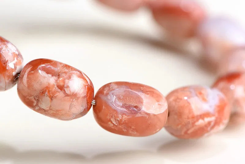 Natural cherry agate bracelet with 10x14mm barrel beads and traditional Ruyi design elements