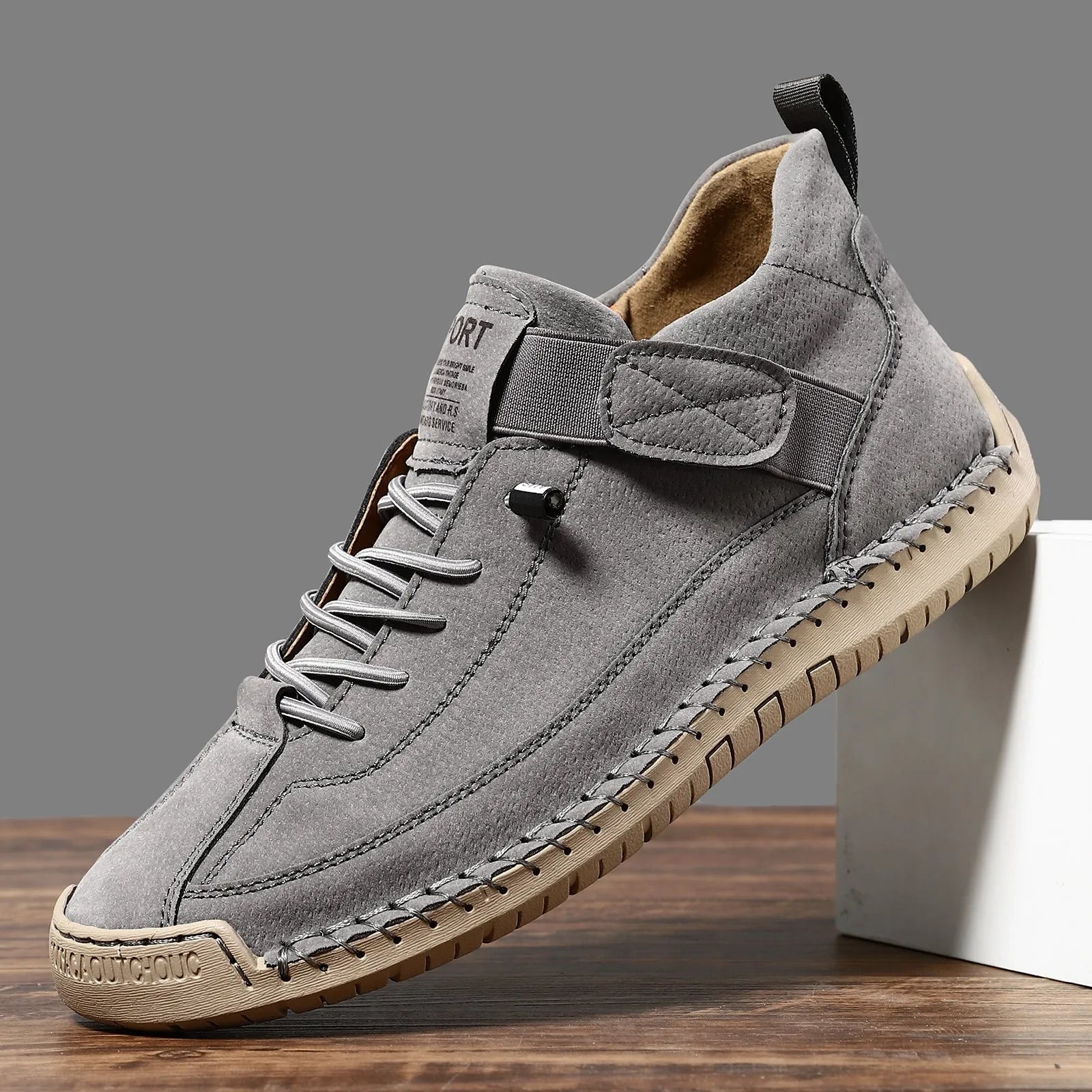 Men's mid-calf black Martin boots with tooling stitching and a flat rubber sole on a white background.